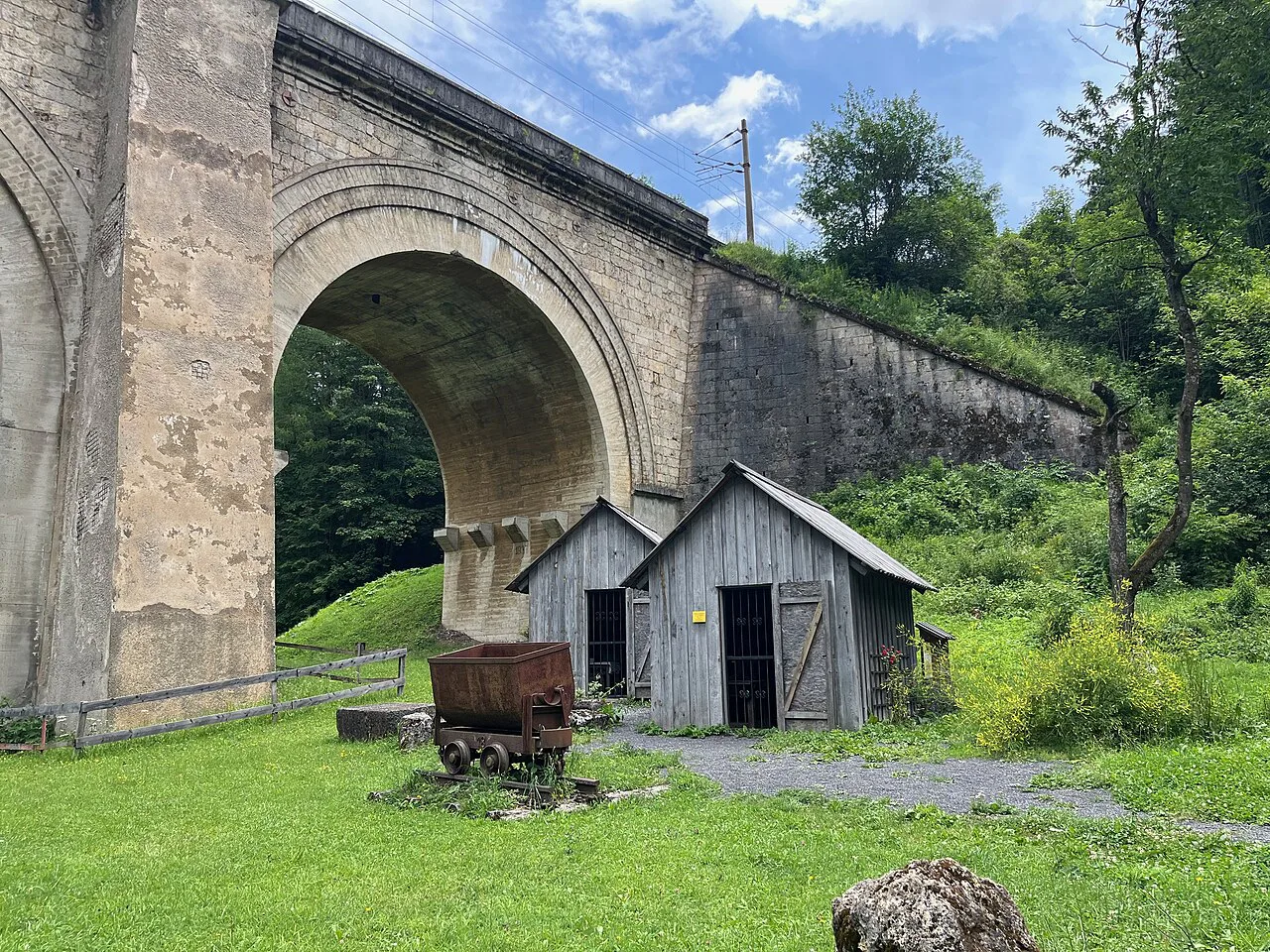 Huts beside a stone viaduct of the Semmering Railway.