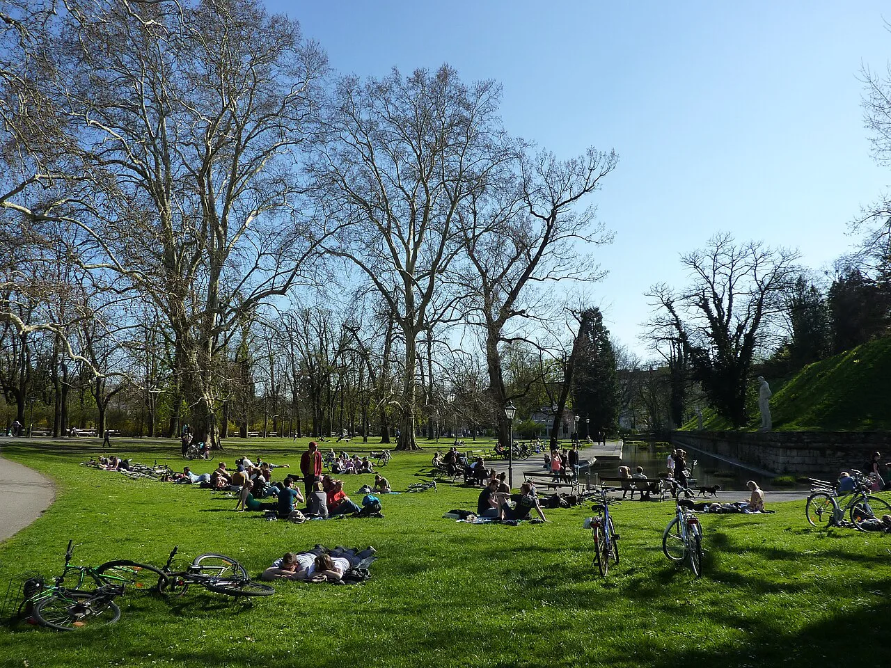 People relaxing on the lawns of the Stadtpark in Graz.