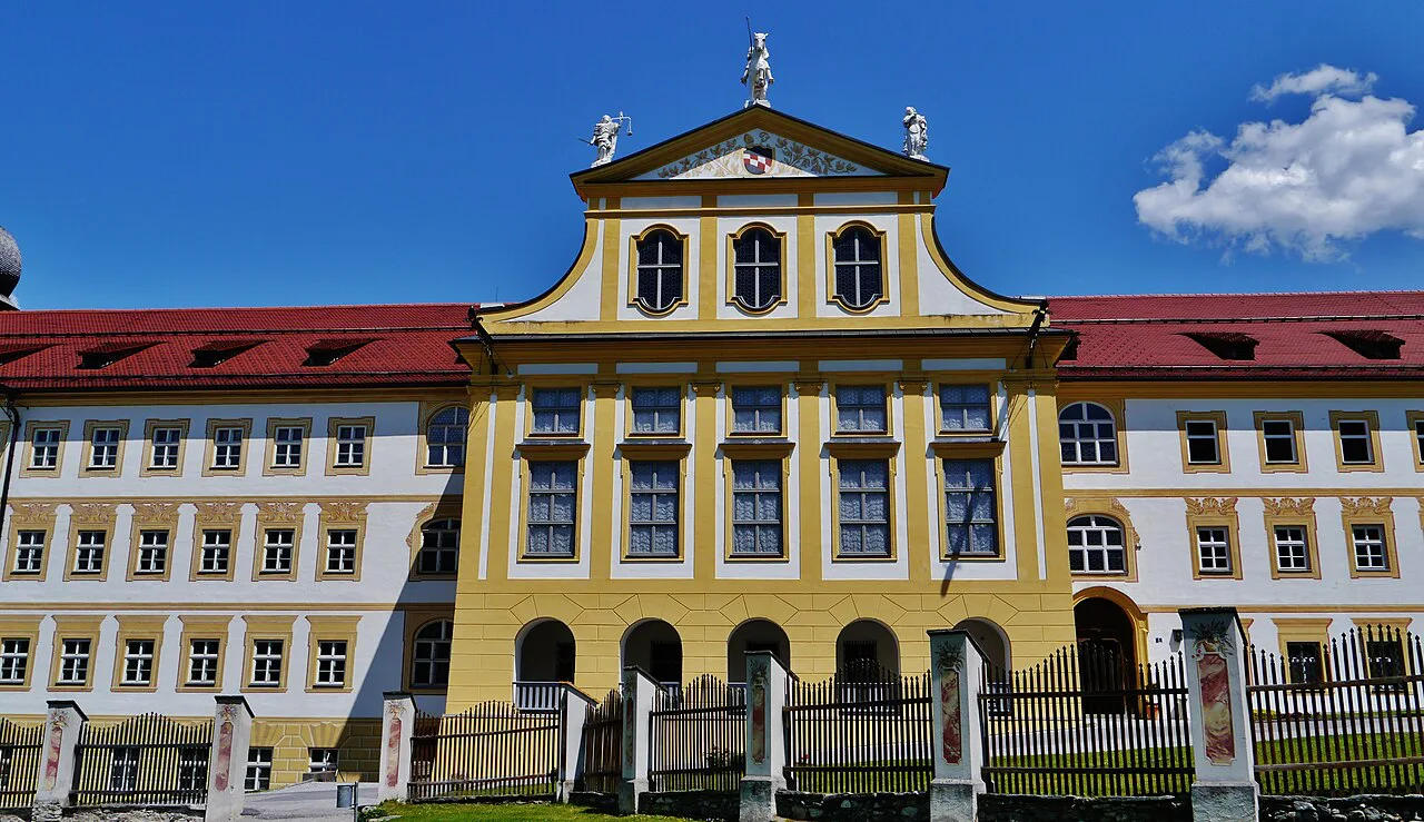 Yellow central facade of the abbatial palace at Stams Abbey, Tyrol.
