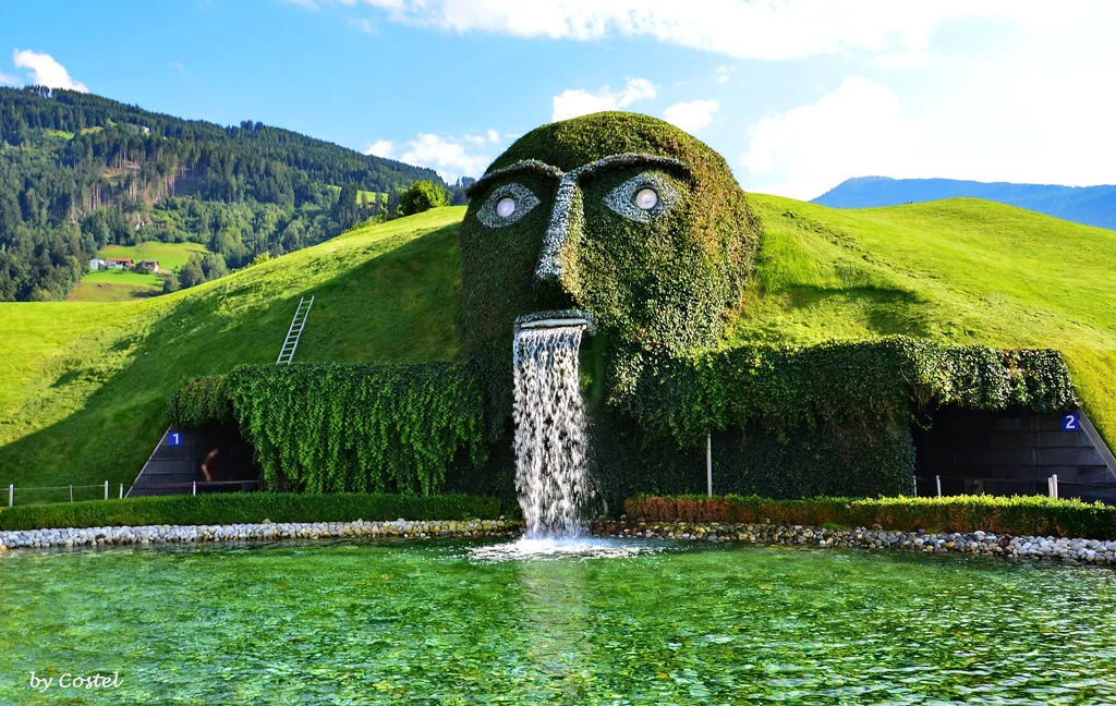 The grass-covered Giant's head and waterfall at Swarovski Crystal Worlds in Wattens.