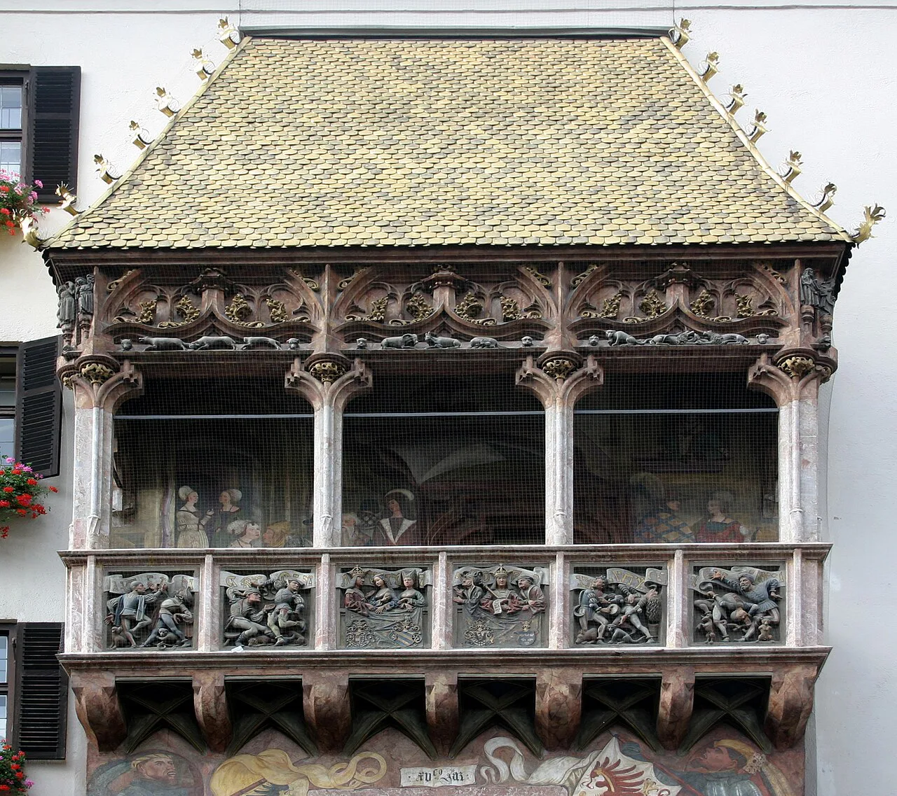 Close view of the carved balconies and gilded copper roof of the Goldenes Dachl in Innsbruck.