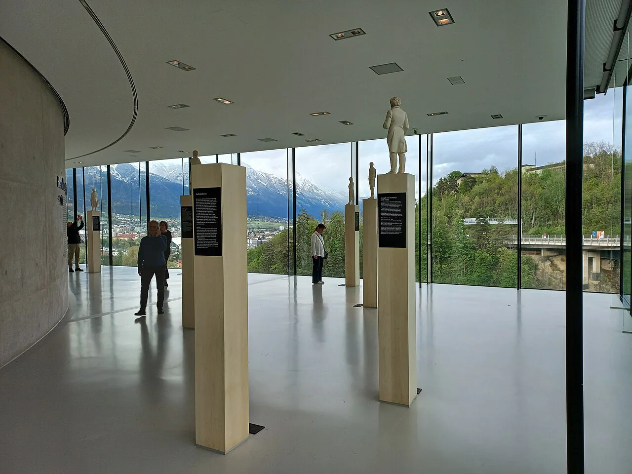 An exhibition hall inside the Tirol Panorama, with views towards the mountains.