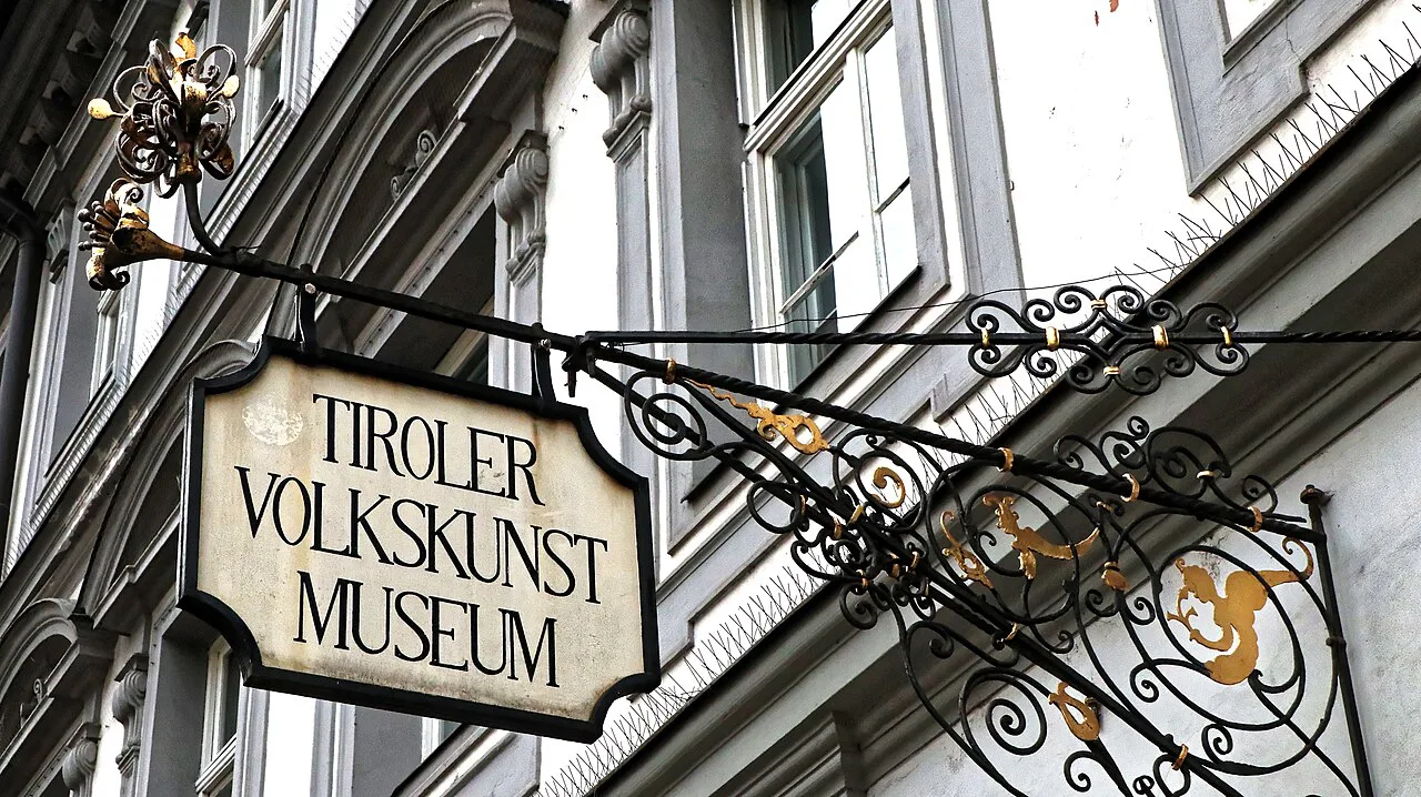 The wrought-iron sign at the entrance to the Tiroler Volkskunstmuseum in Innsbruck.