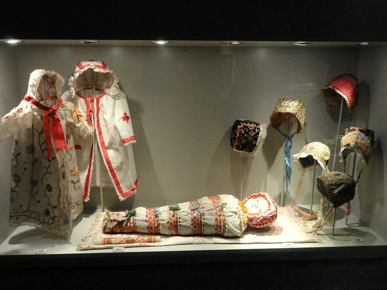 Traditional costumes and headwear on display in the Tyrolean Folk Art Museum in Innsbruck.
