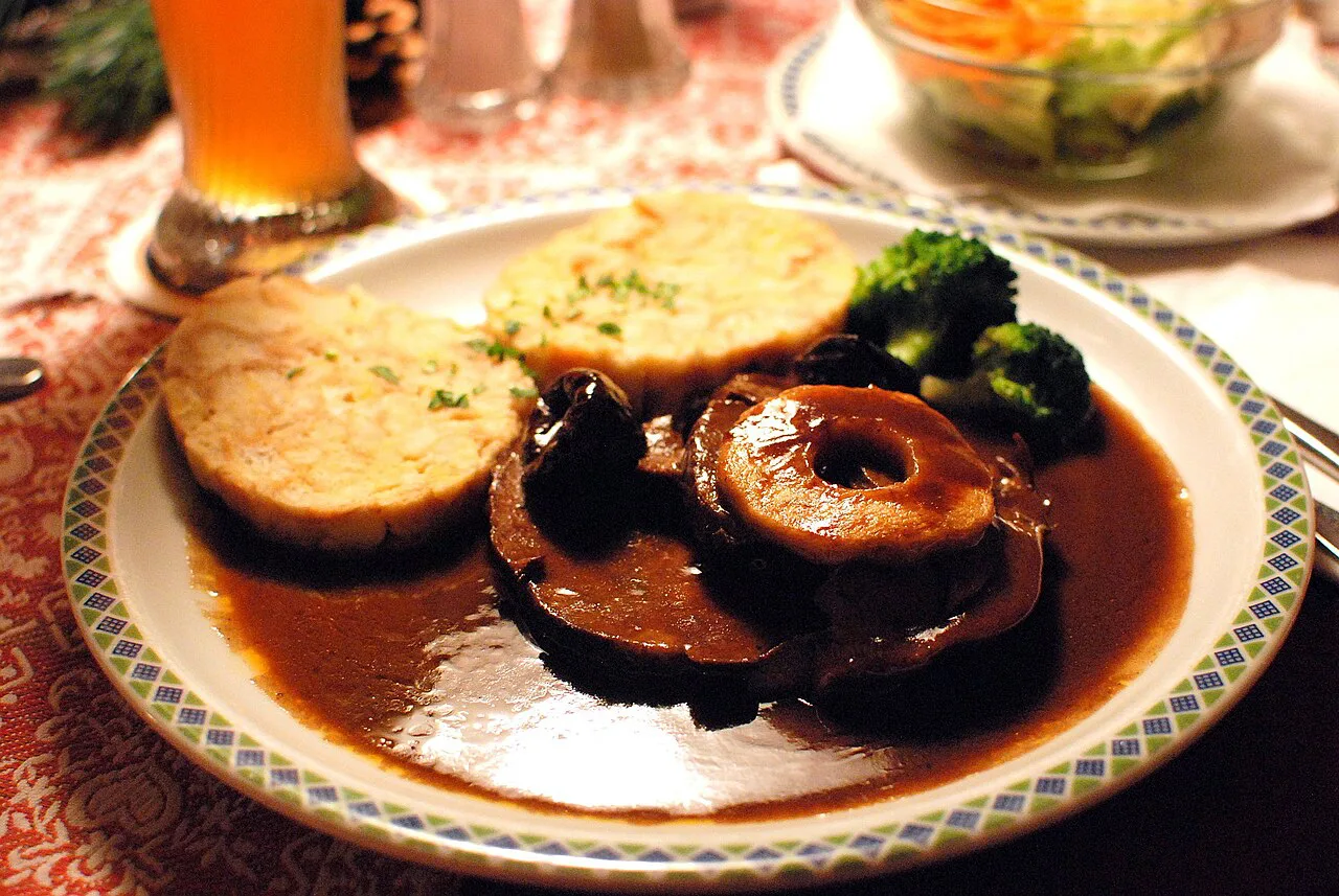 Tyrolean roast wild boar served with sliced bread dumplings.