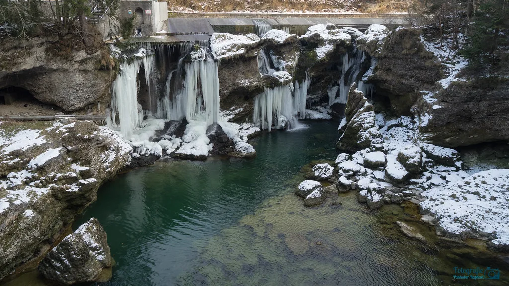 The Traunfall waterfall on the Traun river in Upper Austria, with snow on the rocks.