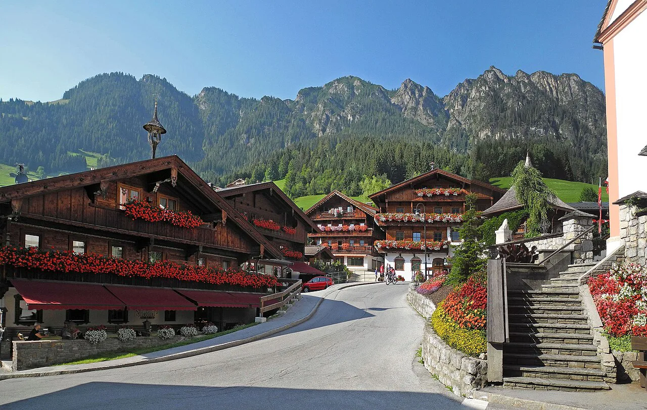 Wooden chalets with flower-filled balconies in the centre of Alpbach, Tyrol.