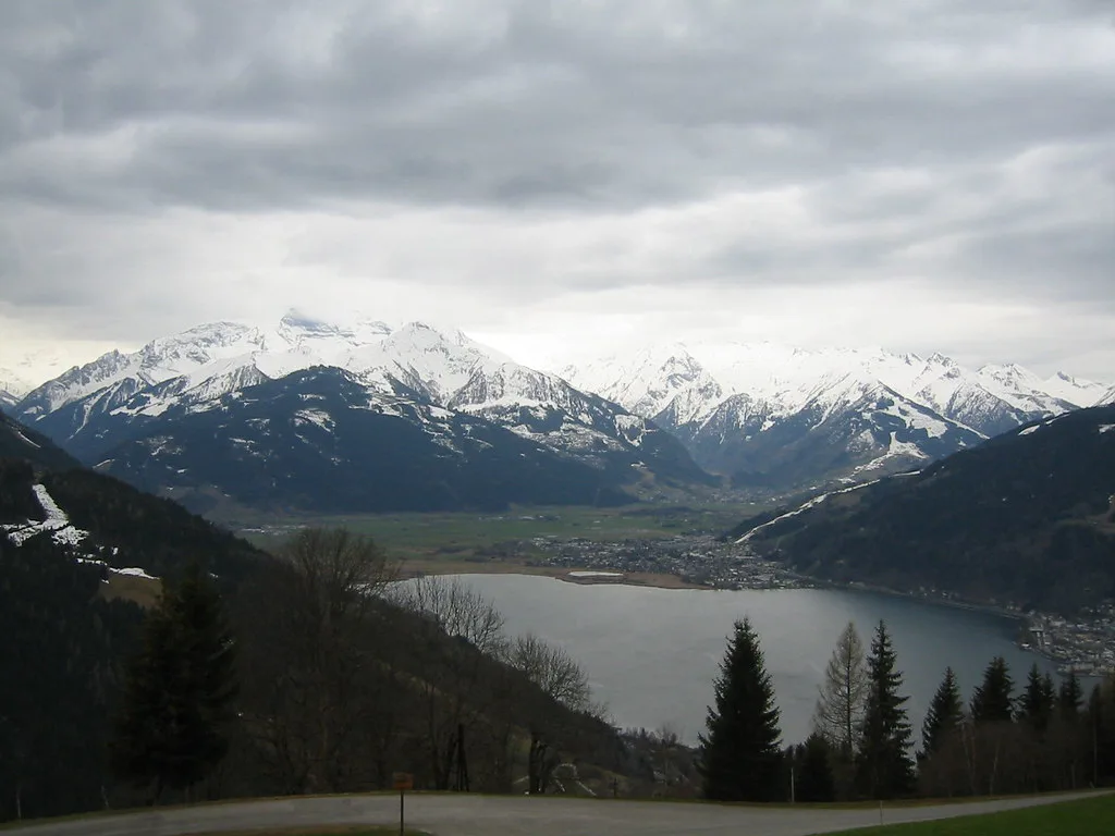 The Zeller See and snow-capped peaks seen from a hillside at Zell am See.