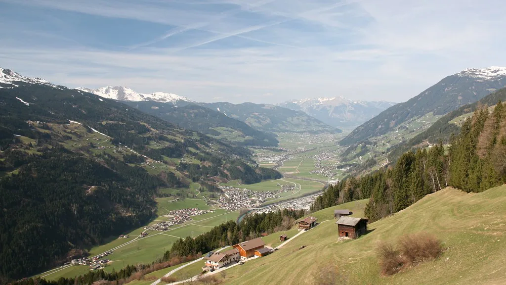 View down the Zillertal valley from a hillside with farm huts.